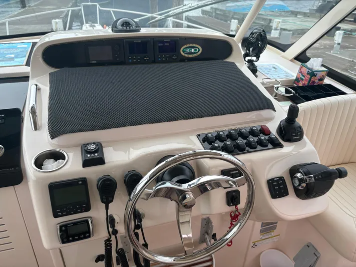  Yacht Photos Pics Helm of 2014 Grady-White Express 330 boat with steering wheel and control panel.