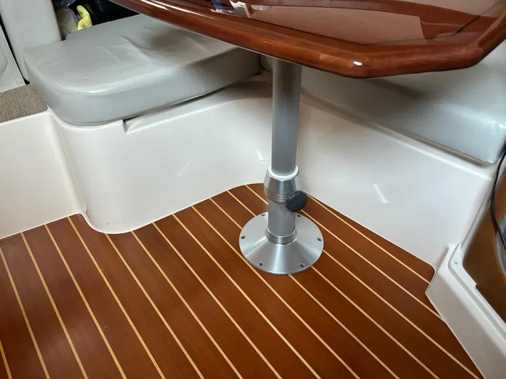  Yacht Photos Pics 2014 Grady-White Express 330 interior with wood flooring and cushioned seating.