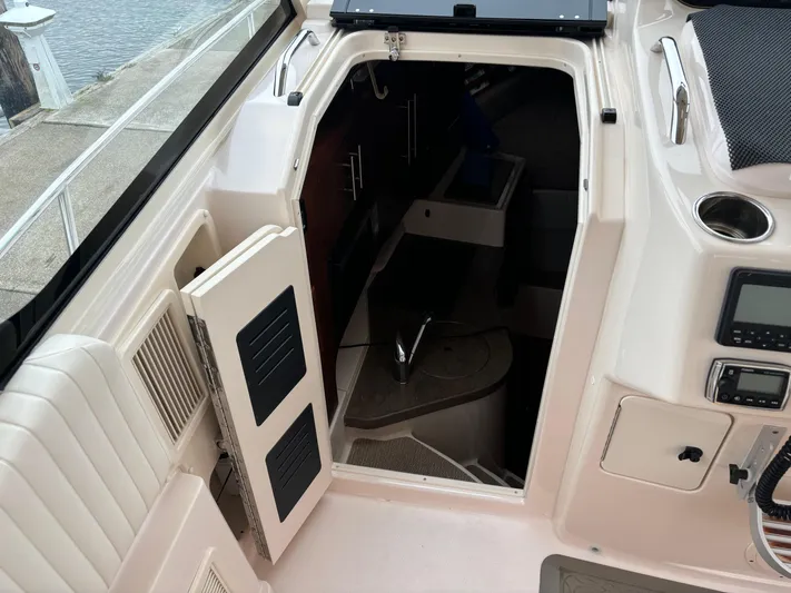 Yacht Photos Pics 2014 Grady-White Express 330 cabin entrance with open door, showcasing interior layout.