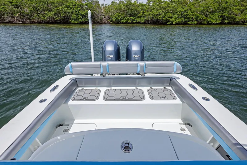  Yacht Photos Pics 2016 Yellowfin 26 Hybrid boat with dual engines on calm water.