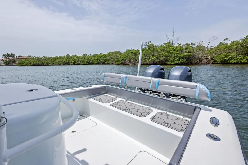  Yacht Photos Pics 2016 Yellowfin 26 Hybrid boat with dual engines on a calm waterway.