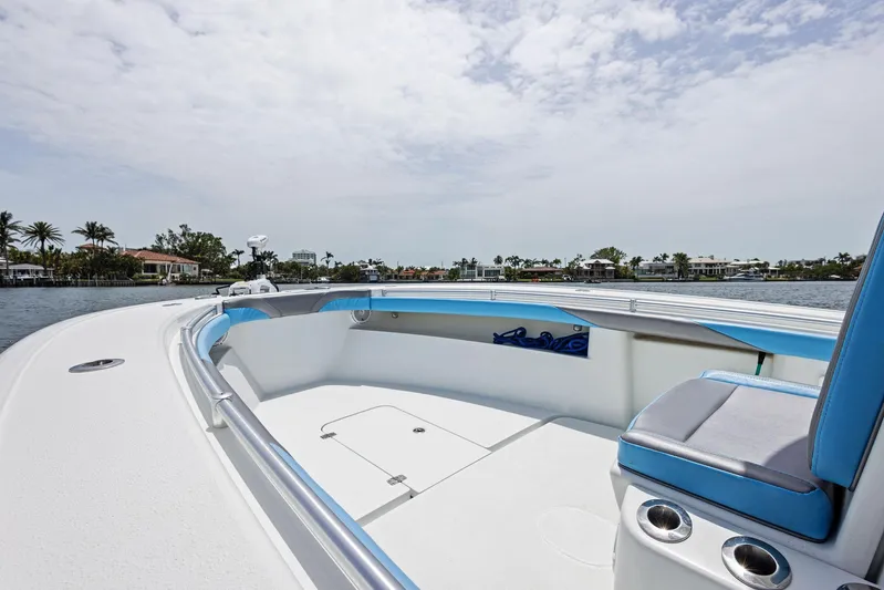  Yacht Photos Pics 2016 Yellowfin 26 Hybrid boat with spacious deck and seating, cruising on a calm waterway.