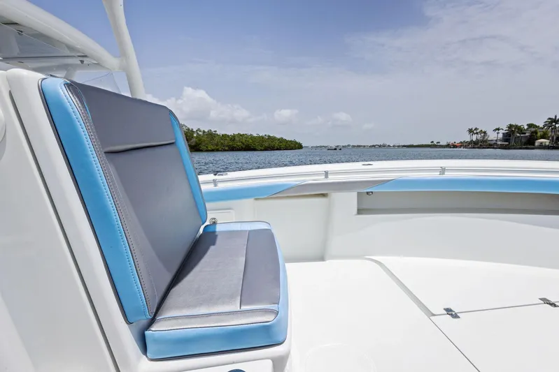  Yacht Photos Pics 2016 Yellowfin 26 Hybrid boat interior with blue and gray seating, scenic water view.