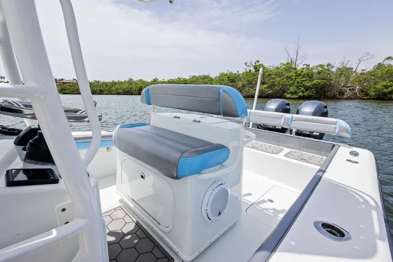  Yacht Photos Pics 2016 Yellowfin 26 Hybrid boat interior with seating, on a calm waterway.