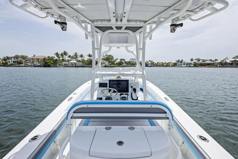  Yacht Photos Pics 2016 Yellowfin 26 Hybrid boat on calm water, featuring a sleek design and modern console.