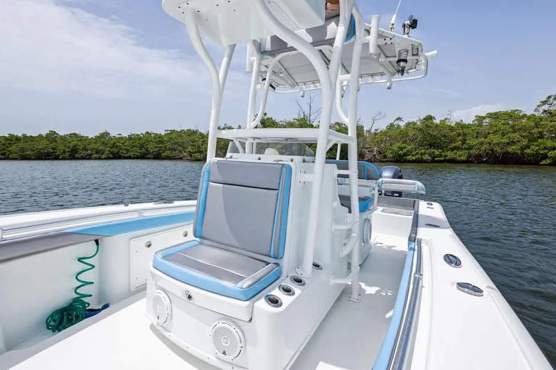  Yacht Photos Pics 2016 Yellowfin 26 Hybrid boat with sleek seating and modern design on calm water.