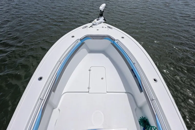  Yacht Photos Pics 2016 Yellowfin 26 Hybrid boat bow on water, featuring sleek design and spacious deck.