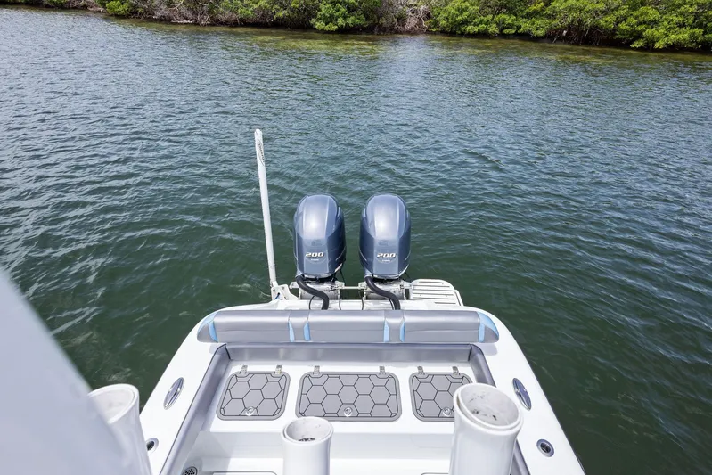  Yacht Photos Pics 2016 Yellowfin 26 Hybrid boat with dual engines on calm water.