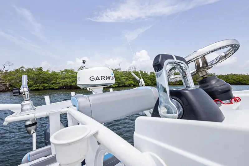  Yacht Photos Pics 2016 Yellowfin 26 Hybrid boat with Garmin equipment on a calm waterway.