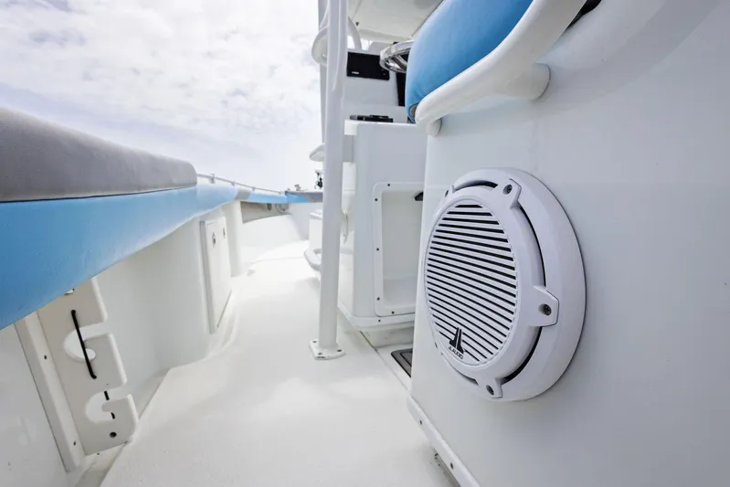  Yacht Photos Pics 2016 Yellowfin 26 Hybrid boat interior with speaker and blue seating.