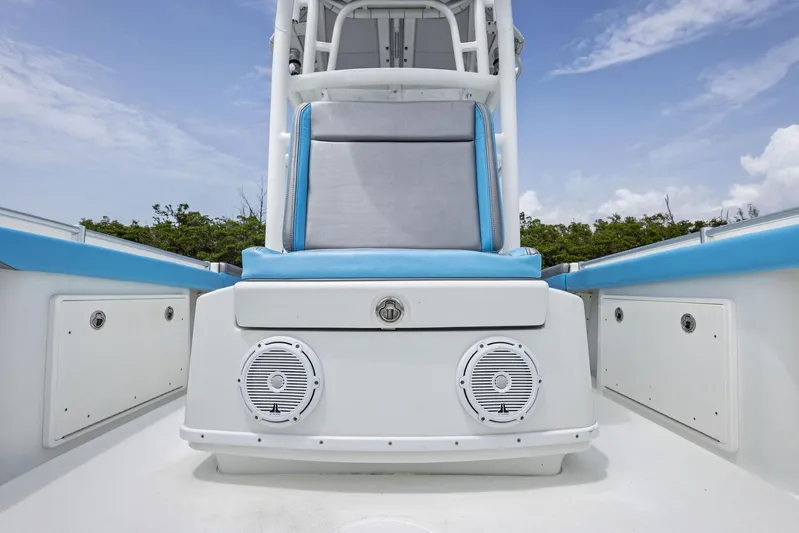  Yacht Photos Pics 2016 Yellowfin 26 Hybrid boat interior with blue seating and speakers.