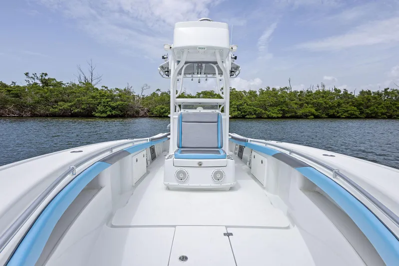  Yacht Photos Pics 2016 Yellowfin 26 Hybrid boat with sleek design, blue accents, and spacious deck.