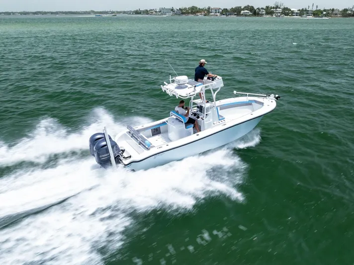  Yacht Photos Pics 2016 Yellowfin 26 Hybrid boat cruising on open water with two passengers.