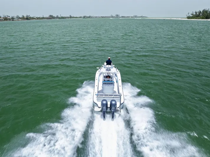  Yacht Photos Pics 2016 Yellowfin 26 Hybrid boat cruising on open water, aerial view.