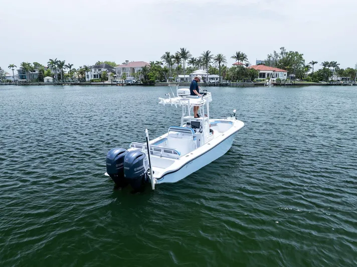  Yacht Photos Pics 2016 Yellowfin 26 Hybrid boat on water with dual engines, near waterfront homes.