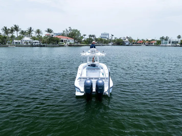  Yacht Photos Pics 2016 Yellowfin 26 Hybrid boat on calm water with scenic waterfront homes.