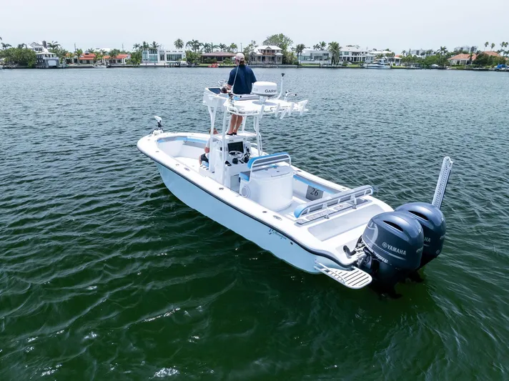  Yacht Photos Pics 2016 Yellowfin 26 Hybrid boat on water with dual Yamaha engines, piloted by a person.