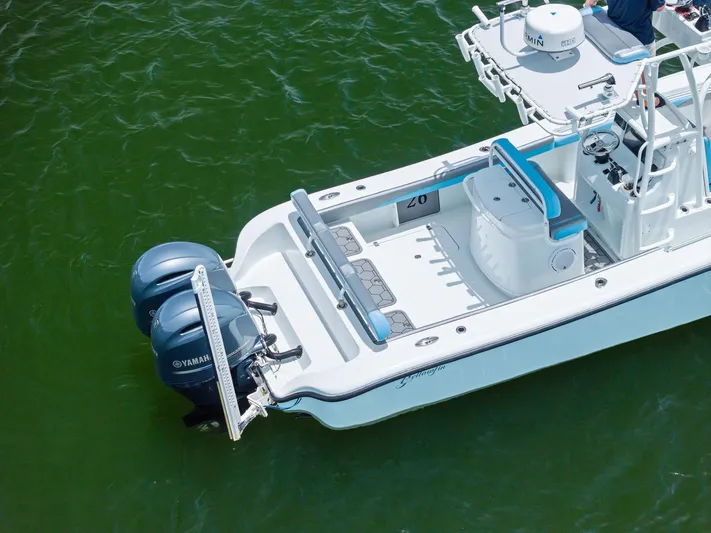  Yacht Photos Pics 2016 Yellowfin 26 Hybrid boat with dual Yamaha engines on green water.