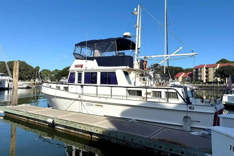 Summer Wind Yacht Photos Pics 1989 Grand Banks 46 Classic yacht docked at marina under clear blue sky.