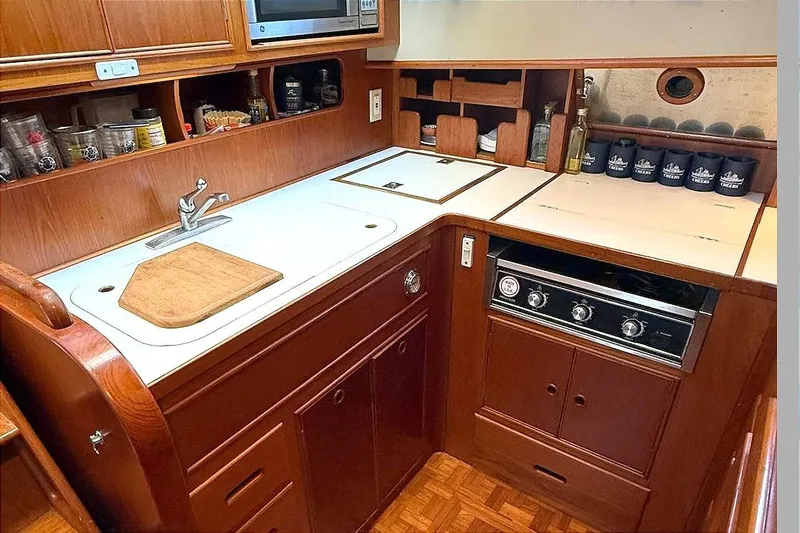 Summer Wind Yacht Photos Pics 1989 Grand Banks 46 Classic yacht kitchen with wooden cabinetry and modern appliances.
