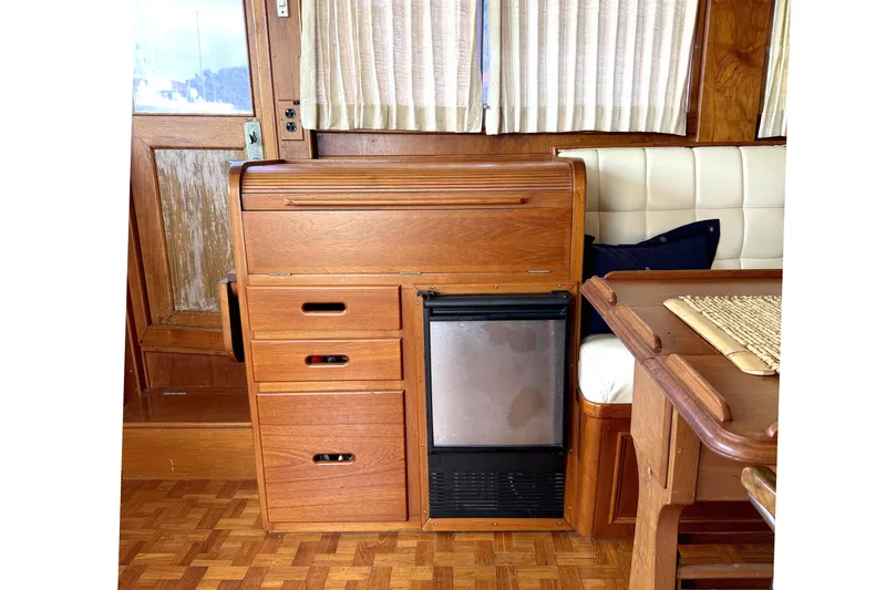 Summer Wind Yacht Photos Pics Interior of 1989 Grand Banks 46 Classic yacht with wooden cabinetry and seating area.