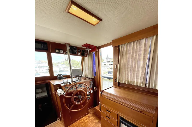 Summer Wind Yacht Photos Pics 1989 Grand Banks 46 Classic yacht interior with wooden helm and cabinetry.