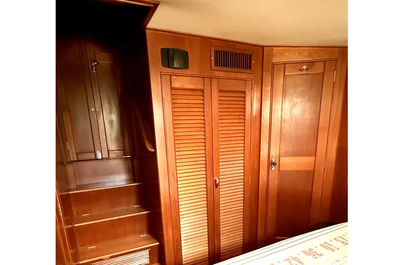 Summer Wind Yacht Photos Pics 1989 Grand Banks 46 Classic interior with wooden cabinetry and cozy bedroom.