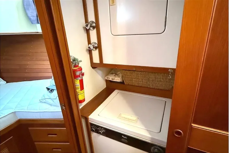 Summer Wind Yacht Photos Pics Laundry area in 1989 Grand Banks 46 Classic yacht with washer, dryer, and fire extinguisher.