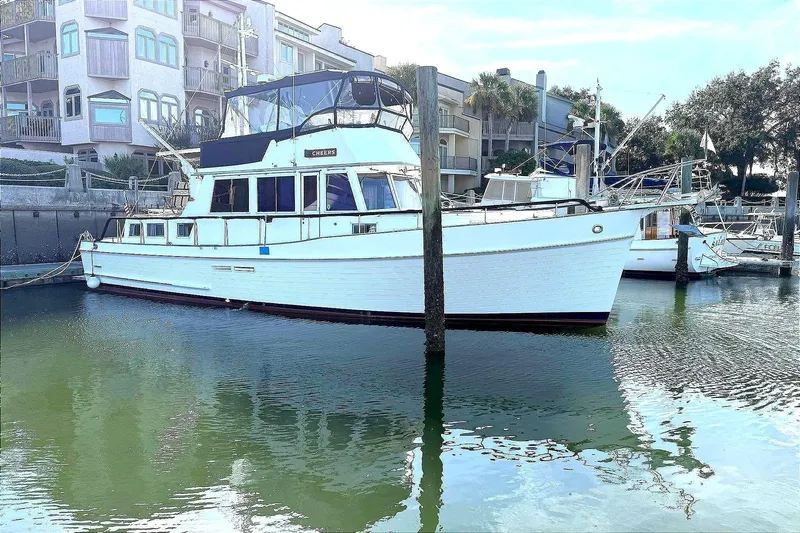 Summer Wind Yacht Photos Pics 1989 Grand Banks 46 Classic yacht docked in a marina, surrounded by waterfront buildings.