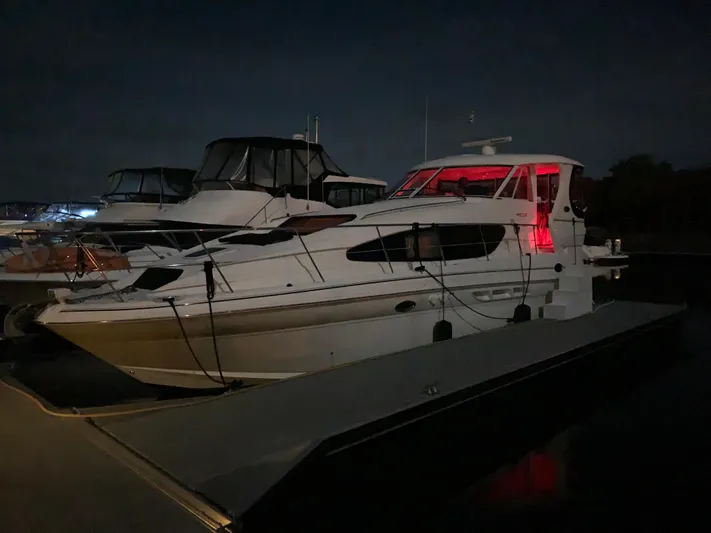 Yacht Photos Pics 2005 Sea Ray 390 Motor Yacht docked at night with red interior lighting.