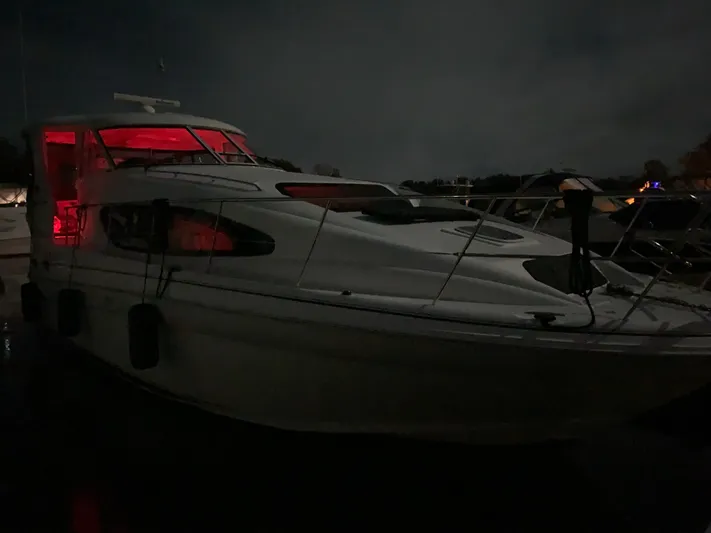  Yacht Photos Pics 2005 Sea Ray 390 Motor Yacht illuminated at night with red interior lighting.