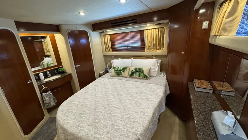  Yacht Photos Pics Luxurious 2005 Sea Ray 390 Motor Yacht bedroom with cozy bed and elegant wood finishes.