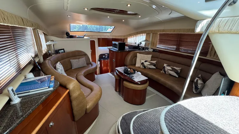 Yacht Photos Pics Luxurious interior of 2005 Sea Ray 390 Motor Yacht with plush seating and elegant decor.