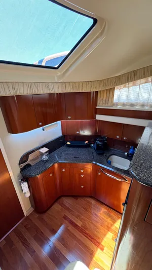  Yacht Photos Pics 2005 Sea Ray 390 Motor Yacht kitchen with wood cabinets and granite countertops.