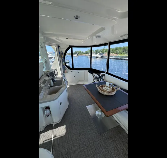  Yacht Photos Pics Interior of 2005 Sea Ray 390 Motor Yacht with dining area and waterfront view.
