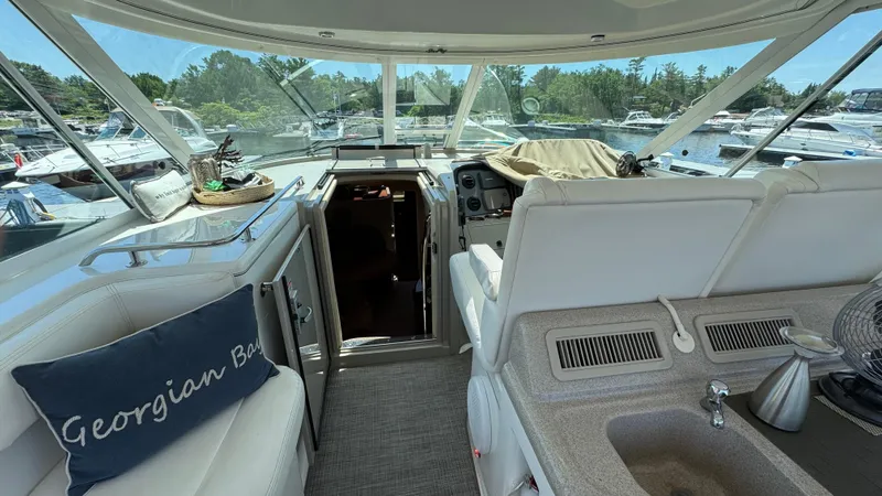  Yacht Photos Pics 2005 Sea Ray 390 Motor Yacht interior with helm, seating, and marina view.