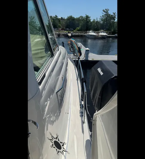  Yacht Photos Pics 2005 Sea Ray 390 Motor Yacht docked by a serene waterfront.