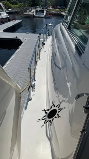  Yacht Photos Pics 2005 Sea Ray 390 Motor Yacht docked, featuring sleek design and sun motif.