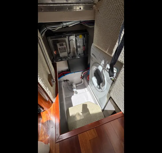  Yacht Photos Pics 2005 Sea Ray 390 Motor Yacht laundry area with washing machine and electrical panel.