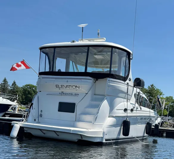  Yacht Photos Pics 2005 Sea Ray 390 Motor Yacht docked, displaying Canadian flag, clear sky background.