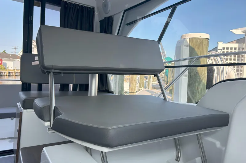  Yacht Photos Pics 2024 Beneteau Antares 9 interior seating with modern design and comfortable cushions.