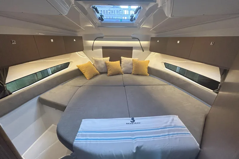  Yacht Photos Pics 2024 Beneteau Antares 9 cabin interior with cozy bedding and modern design.