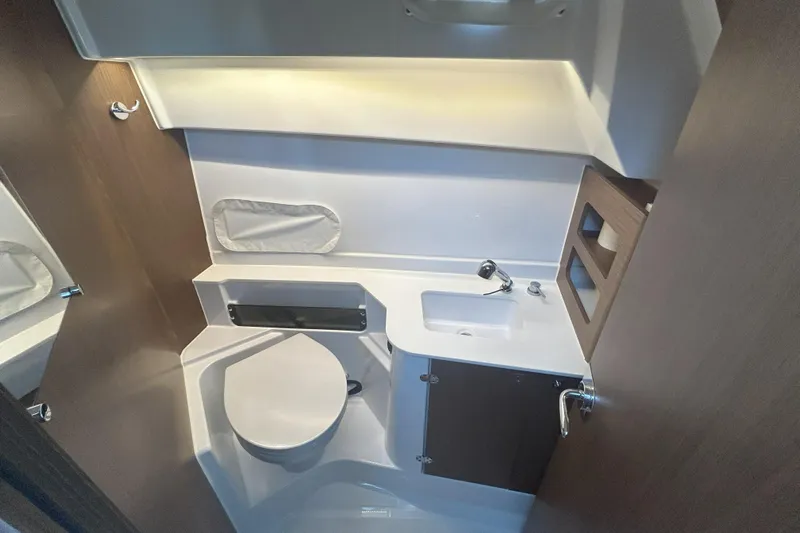  Yacht Photos Pics 2024 Beneteau Antares 9 bathroom interior with modern fixtures and compact design.