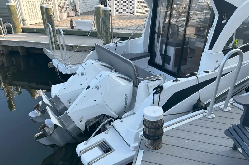  Yacht Photos Pics 2024 Beneteau Antares 9 boat docked, featuring dual Mercury outboard engines.