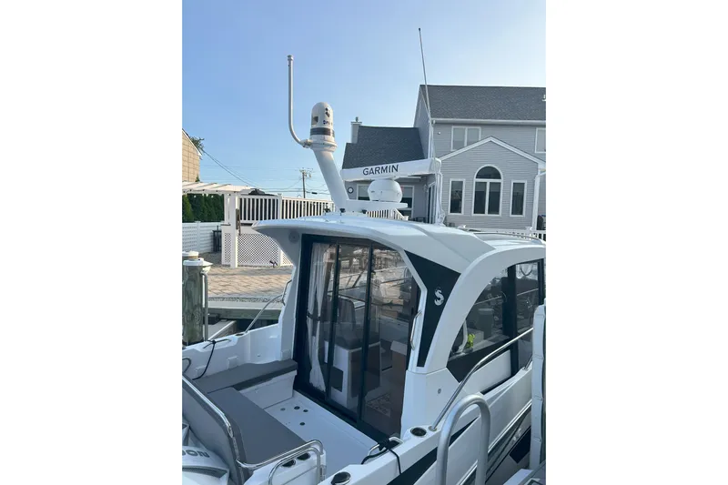  Yacht Photos Pics 2024 Beneteau Antares 9 boat docked, featuring Garmin equipment and modern design.