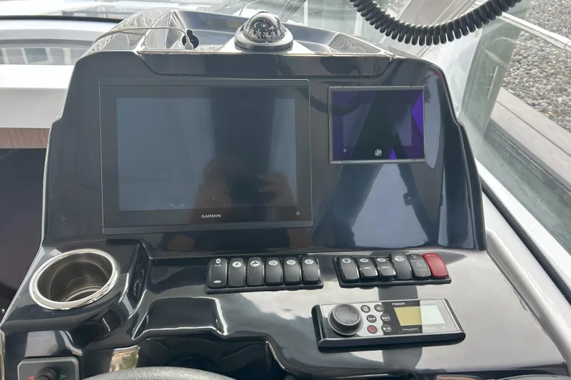  Yacht Photos Pics Control panel of 2024 Beneteau Antares 9 with Garmin display and navigation controls.
