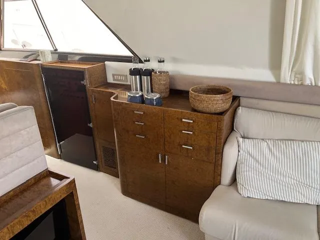  Yacht Photos Pics Interior of 1990 Riva Corsaro 20 yacht with wooden cabinetry and beige seating.