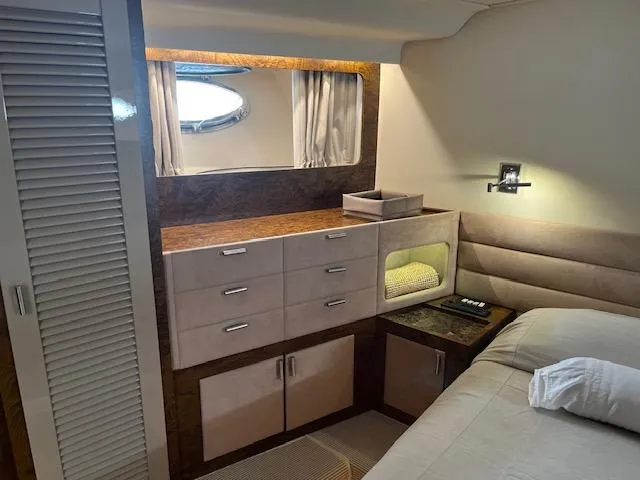  Yacht Photos Pics Interior of a 1990 Riva Corsaro 20 yacht, featuring a cozy bedroom with storage.
