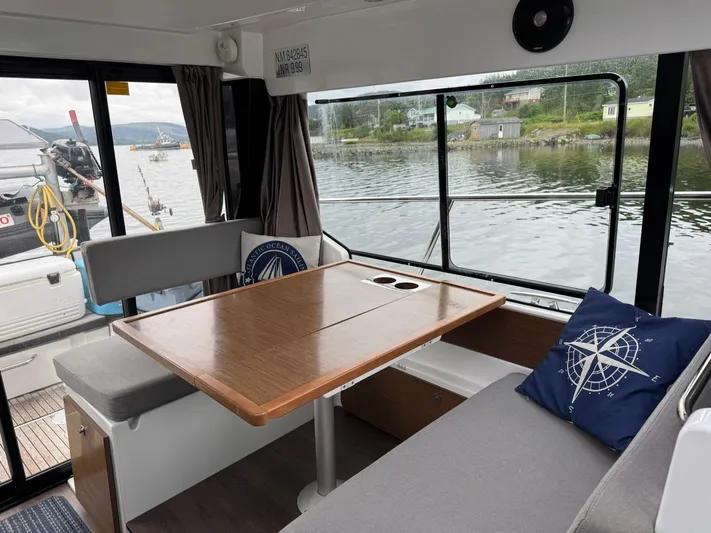  Yacht Photos Pics Interior of 2020 Jeanneau NC 1095 boat with dining area and waterfront view.