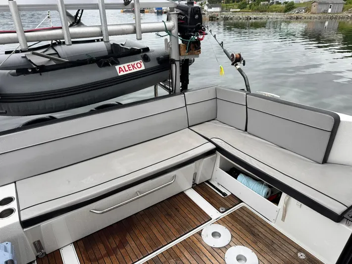  Yacht Photos Pics Jeanneau NC 1095 boat deck with seating, Aleko inflatable, and fishing equipment, 2020 model.